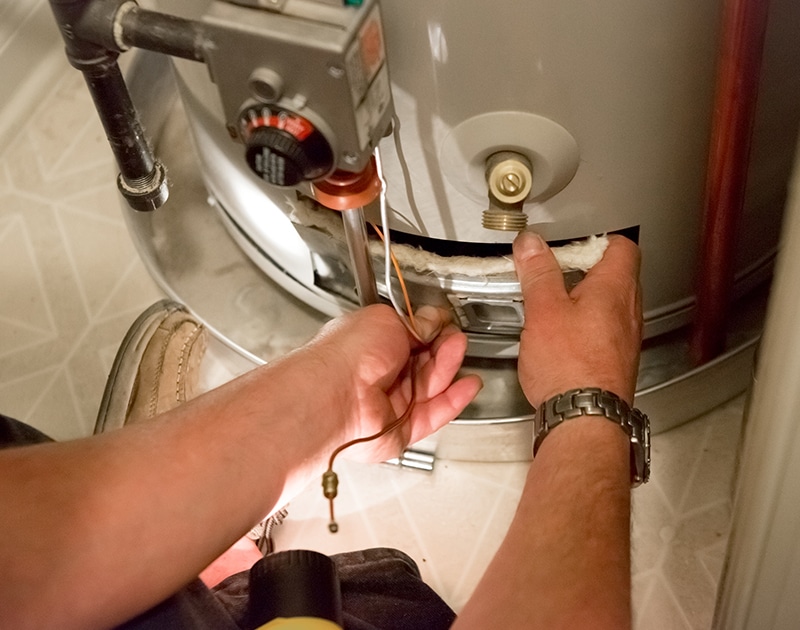HVAC technical repairing a water heater