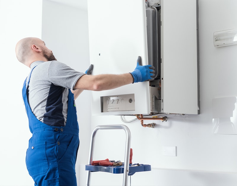 An HVAC technician completing repairs