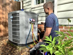 Man sitting outside working on home comfort system