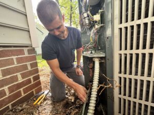 Man working on outdoor AC unit