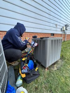 Man working on outdoor heating and cooling system